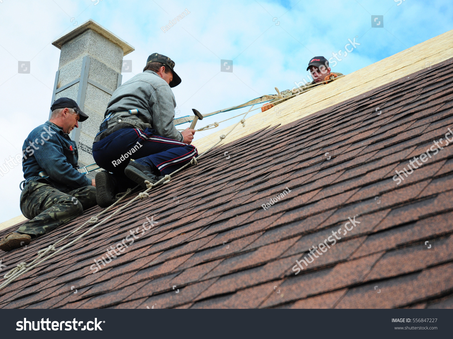 stock-photo-kiev-ukraine-january-roofing-construction-roofing-contractors-install-new-house-556847227